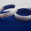 A heart embossed silver wedding rings