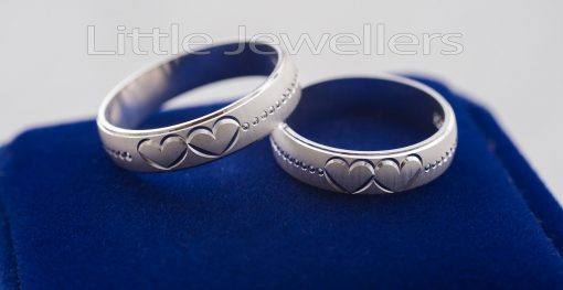 A heart embossed silver wedding rings