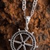 This stylish and well-detailed ship wheel necklace is crafted from solid silver and symbolizes the path of life