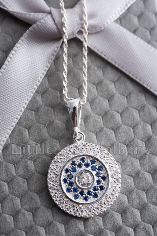 A simple and elegant circle of life necklace that's embellished with white & blue stones