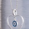A fine and elegant 925 sterling silver heart shaped necklace with a blue charm center