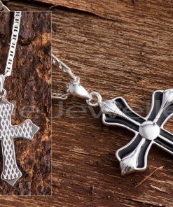 This lovely two-sided silver cross necklace has a rhodium finish and is beautifully intricate.