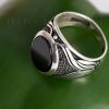 A sleek sterling silver men's ring that is uniquely detailed along the band.