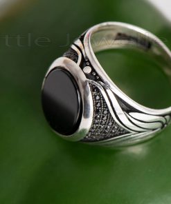 A sleek sterling silver men's ring that is uniquely detailed along the band.
