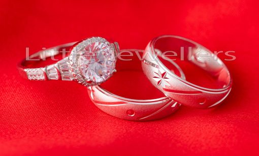 A beautiful blend of silver star engraved wedding ring set that is coupled with a stunning engagement ring.
