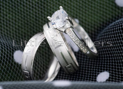 celebrate your love with this pair of silver wedding rings accompanied by an exquisite engagement ring