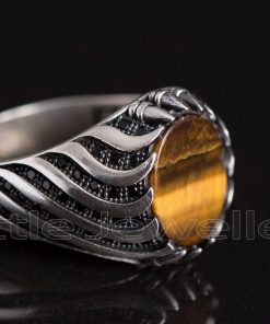 This silver man's ring is made of a silky tiger eye stone with a smooth texture and a honey-like sheen.