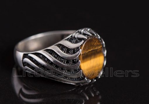 This silver man's ring is made of a silky tiger eye stone with a smooth texture and a honey-like sheen.