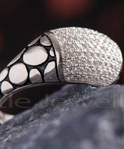 A silver ring with cubic zirconia accent stones that is suitable for both men and women. Handcrafted in exquisite silver, this piece is meant to be worn on a daily basis.