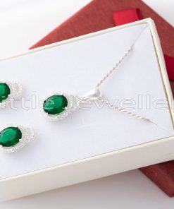 The silver and green necklace is delicate but powerful, and it draws attention to the neck.