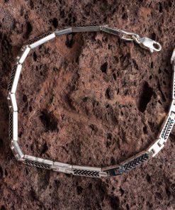 This men's bracelet is made of high-quality silver metal and features a black pattern design on the surface, giving it a very luxurious appearance.