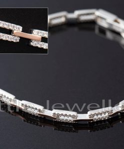 This two-toned sterling silver bracelet is embellished with stunning cubic zirconia stones and looks great with any outfit. It also makes an excellent gift.