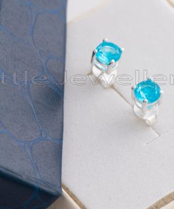 These dainty lab-created aquamarine stud earrings are framed in sterling silver and are perfect for everyday wear.