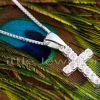 A petite cross pendant necklace with a glittering cubic zirconia accent and a slim box chain that catches the light brilliantly.