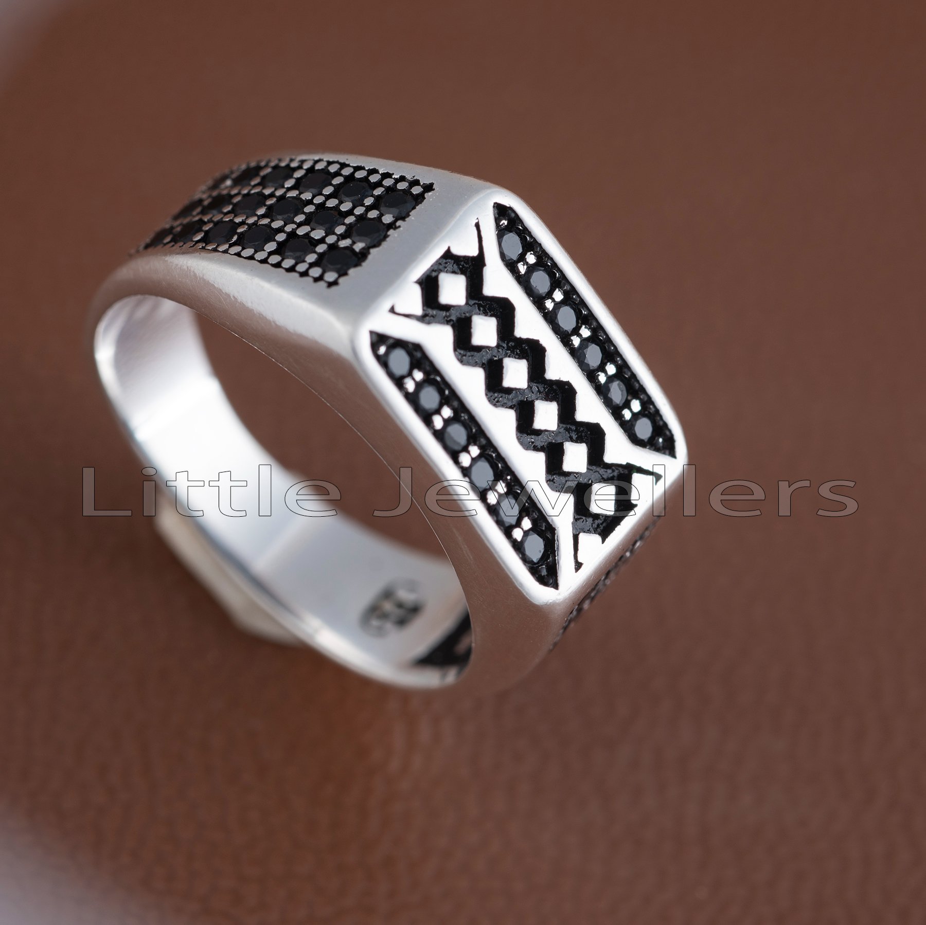 A sterling silver man's ring with a simple, elegant design that adds the final touch to any outfit.