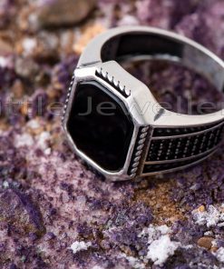 A spectacular men's ring crafted from shiny sterling silver & adorned with pave-set black stones.
