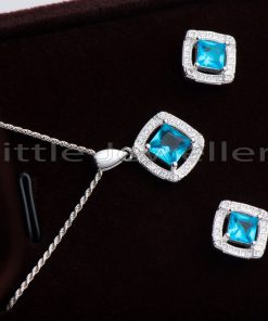 This necklace and earring set is made of solid silver and features a delicate design accented with an aquamarine stone.
