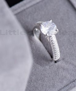 The elegant four claw pave engagement ring has a high silver polish and wraps neatly around the finger.