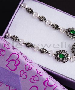 This alluring emerald green silver bracelet set with captivating marcasite stones is sure to charm you.