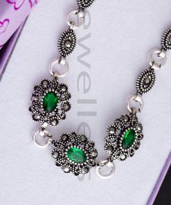 This alluring emerald green silver bracelet set with captivating marcasite stones is sure to charm you.