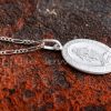 This lovely necklace has a miraculous medal pendant of the Sacred Virgin Mary strung on a silver figaro chain that you will cherish for many years.