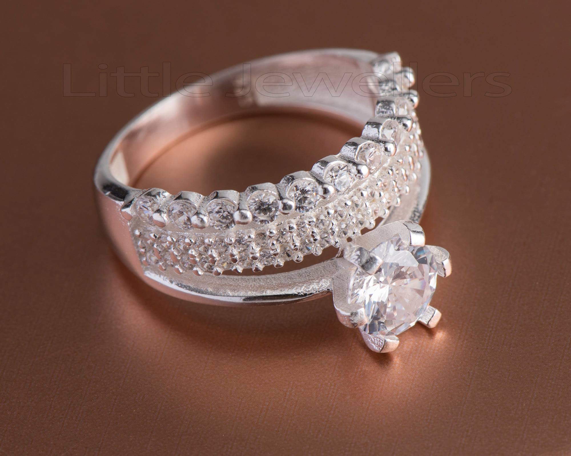 This engagement ring is stunning. A thick band with clear stones in an elegant and simple design.