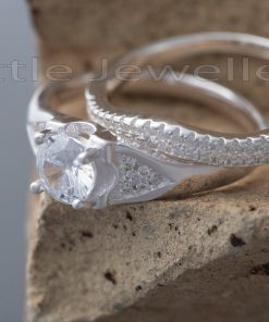 This exquisite double engagement ring is expertly made with a modern style that uniquely wraps around your finger.