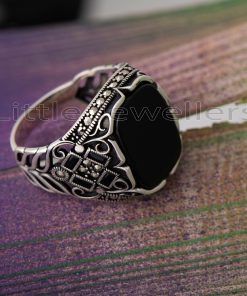 Add a touch of elegance and authority to your look with this bold and beautiful Intricately Crafted Silver Ring featuring an Onyx black zirconia stone embraced by marcasite.