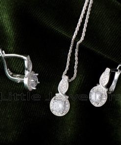 Make a statement with this dazzling silver necklace set. Featuring a delicate halo design pendant, and matching earrings