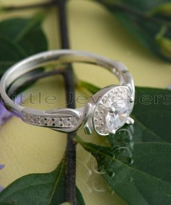 This engagement ring boasts a gorgeous halo design that is sure to capture your heart. Crafted from exquisite sterling silver, it features a unique and eye-catching pattern on the side that is sure to leave her breathless.