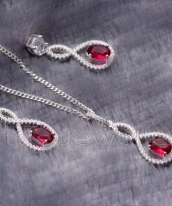 Make her smile with this beautiful sterling silver necklace and earrings set featuring a stunning red gem. The unique design catches the eye and will be sure to turn heads every time she wears it.