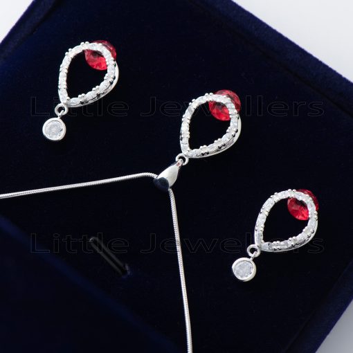 Find the perfect addition to your wardrobe with this stunning silver necklace set. Featuring a shimmering red gem centerpiece & exquisite dangling earrings, you'll be feeling like a queen in no time!