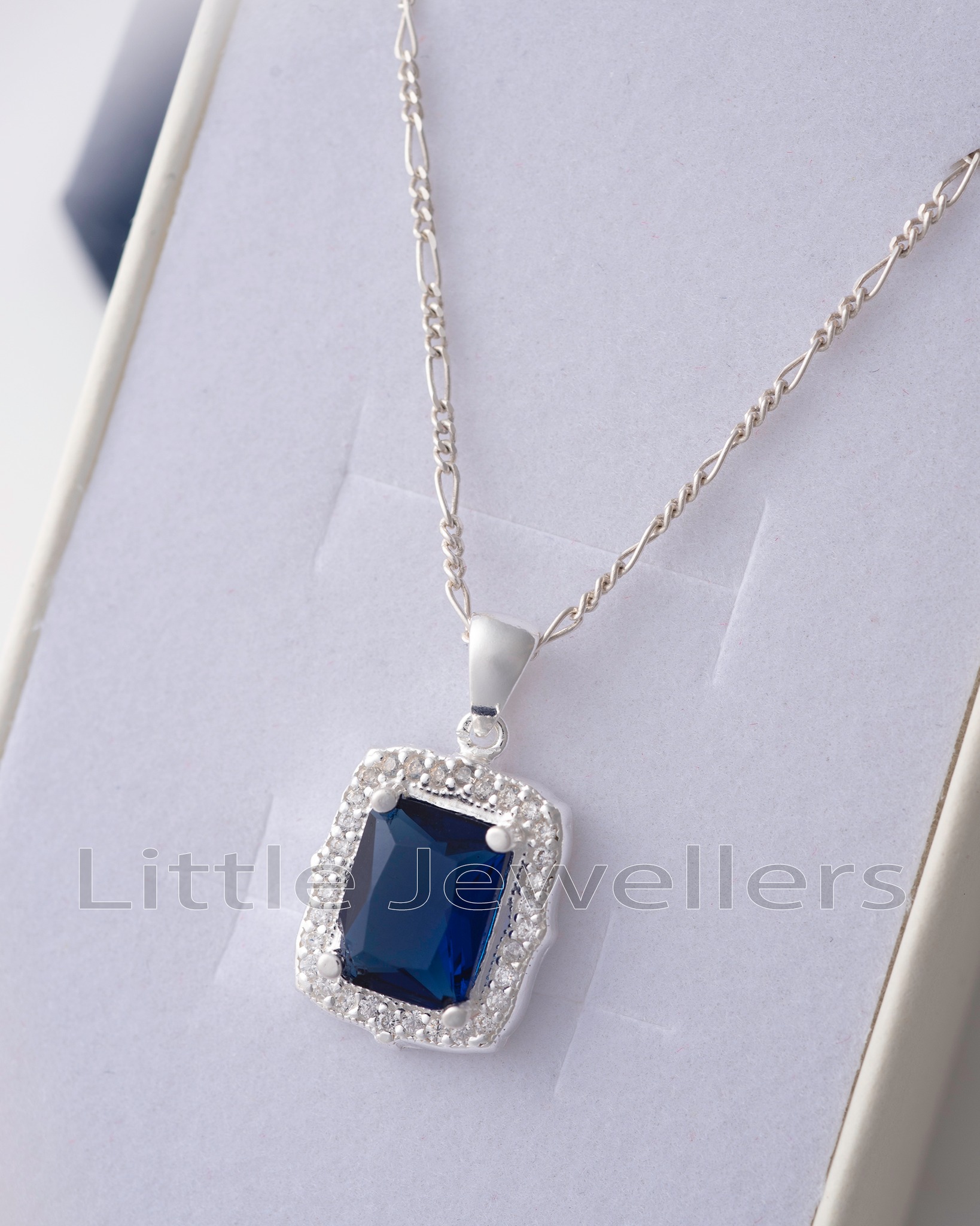 Add a touch of elegance to your look with this stunning Sterling Silver CZ Sapphire Blue Necklace. Its beautiful sapphire blue color and figaro silver chain make it perfect for everyday wear.