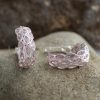 Step into sophistication with these exquisite silver earrings. Boasting a beautiful pink shimmer, these earrings come with a latch back design and captivating pink stones that will make you shine.