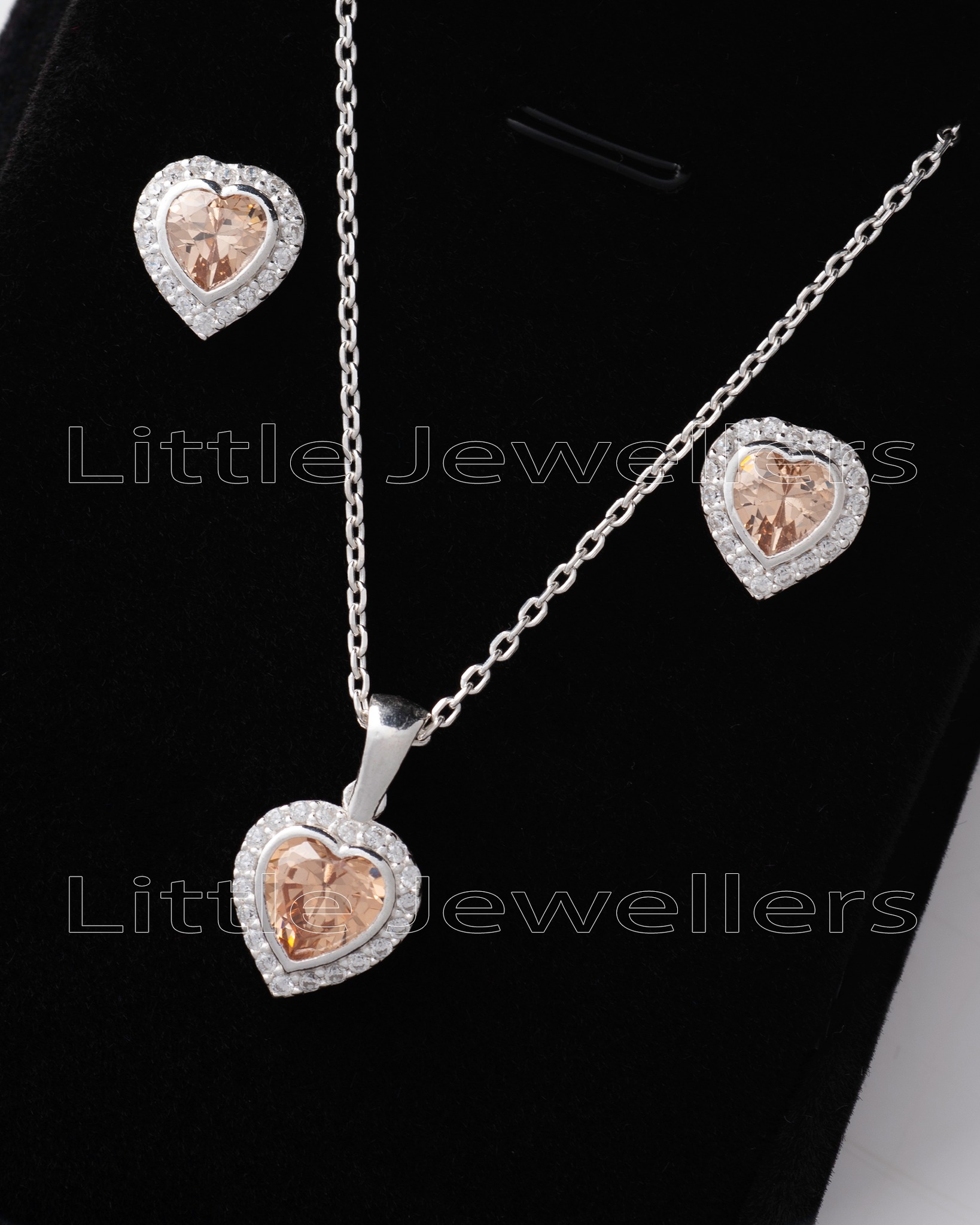 Show your wife your love with this stunning champagne heart shaped silver jewelry gift set. Perfect for anniversary gifts, this elegant set is the perfect way to let her know how much you care.