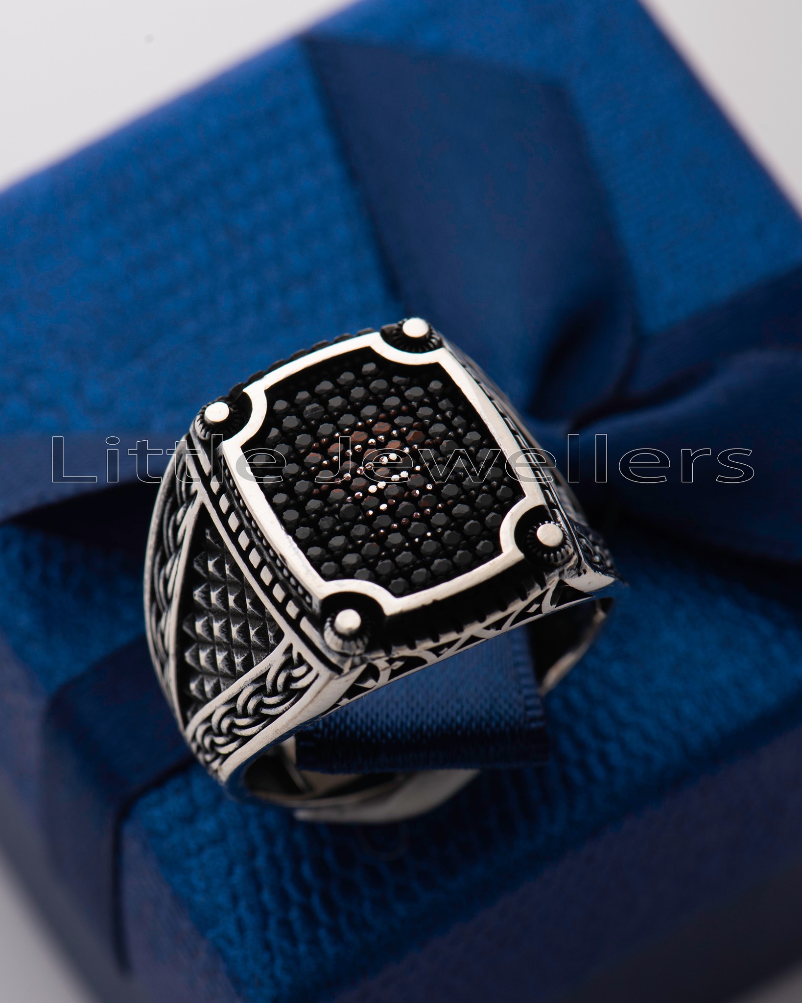 Showcase your bold and masculine side with our stylish silver ring for men featuring black stones and intricate patterns. Elevate your look now