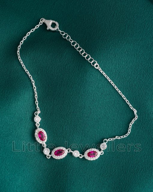 A Minimalist Silver Bracelet with Ruby Red CZ Stones, the perfect embodiment of understated elegance.